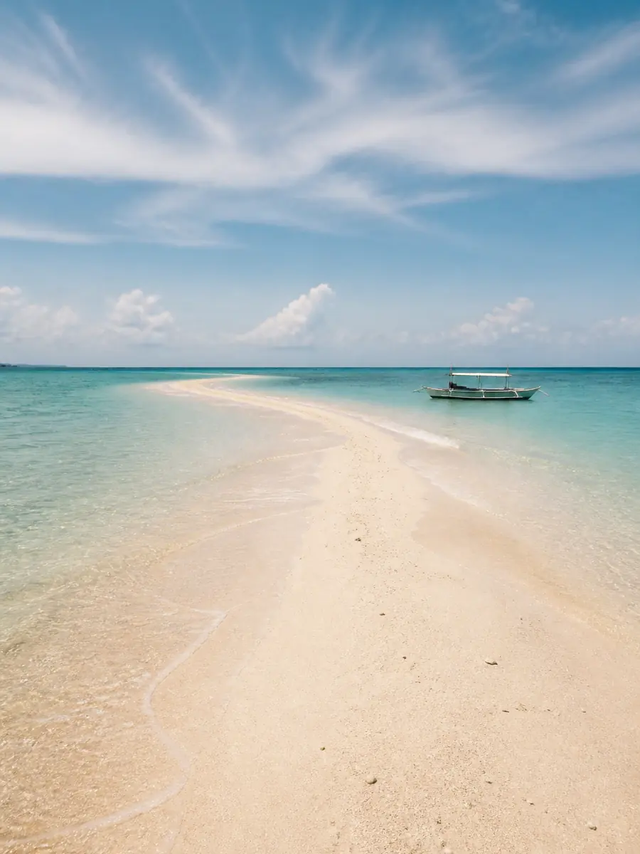 A bare sandbar surrounded by clear sea, a classic island-hopping stop