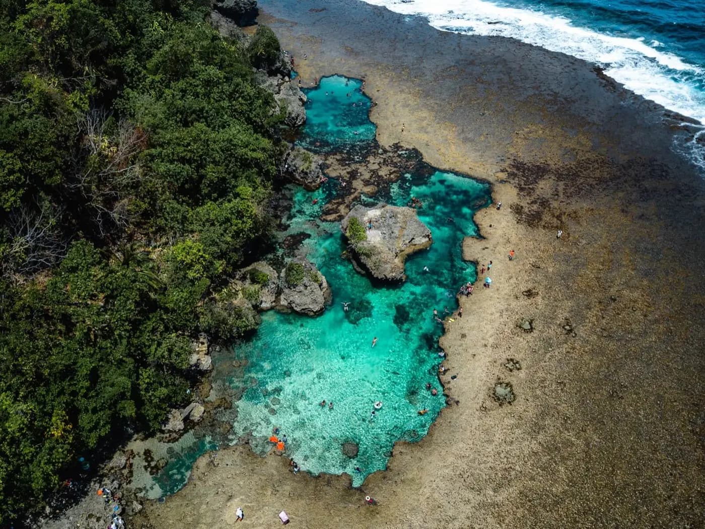 Aerial view of the turquoise Magpupungko rock pools on the Siargao coast, a popular private land-tour stop